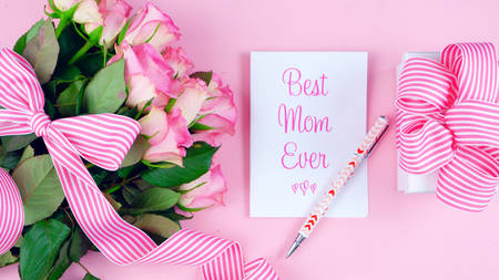 Happy Mothers Day overhead with roses, Best Mom Ever card and gift on pink wood table.の写真素材