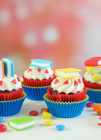 Bright colorful Back to School theme cupcakes with candy sugar art book topper decorations, childrens party celebrations.の写真素材