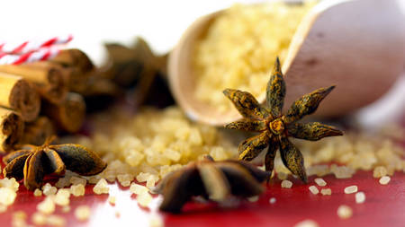 Coffee sugar, cinnamon and star anise coffee sweetener macro closeup on vintage red wood table, selective focus.の写真素材