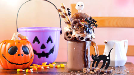 On-trend Happy Halloween theme sweet and salty chocolate freak shakes milkshakes decorated with candy, pretzels and donuts.の写真素材