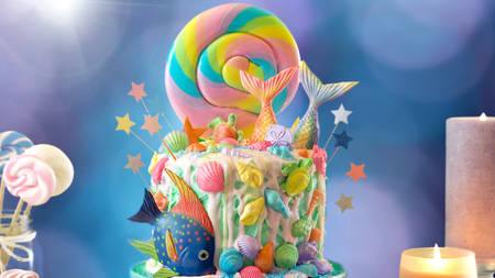 Mermaid theme candyland cake with colorful glitter tails, shells and sea creatures toppers for childrens, teens, novelty birthday and party celebrations.の写真素材