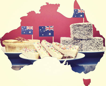 Map of Australia showing traditional Aussie tucker party food, lamingtons, fairy bread and meat pies, with toothpick Australian flags with applied vintage wash filter.の写真素材