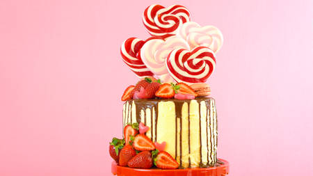 St Valentines Day on-trend candyland fantasy drip novelty cake decorated with heart shaped...