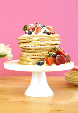 Shrove Pancake Tuesday, last day before Lent, stack of pancakes cake prepared with layers of whipped...
