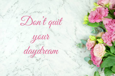 White marble texture  with pink flowers border frame and inspirational, Don't quit your daydream, text greeting.の写真素材