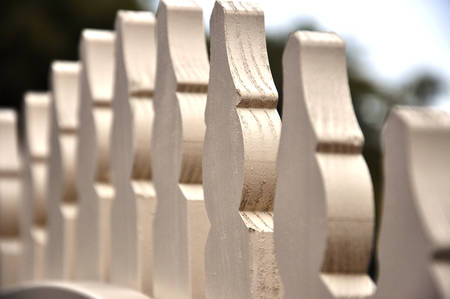 Macro closeup white picket fence gate, selective focus.の写真素材