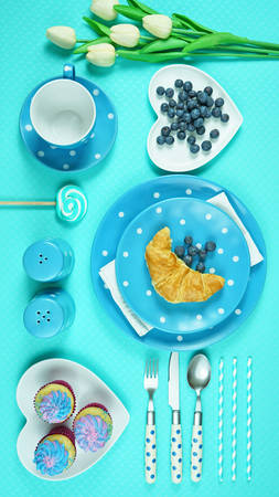 Modern bright colorful blue theme morning breakfast or brunch table setting, flat lay.の写真素材