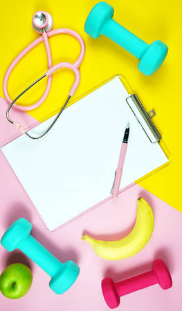 Healthy lifestyle prescription for good health concept flatlay with stethoscope, healthy food, and exercise equipment on modern pastel background.の写真素材