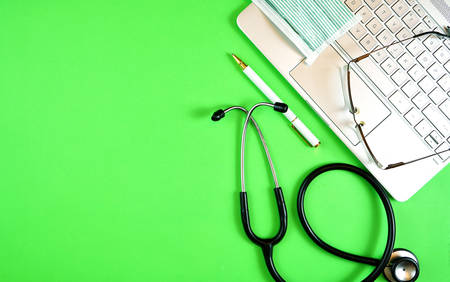 Prescription for good health overhead stop motion with doctor's desk, rx form, stethoscope, healthy fresh food on symbolic green background.の写真素材