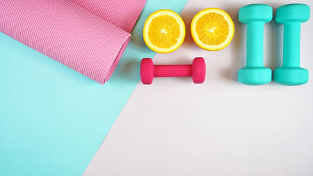 Health and fitness concept flat lay with exercise equipment on modern colorful background with copy space.の写真素材