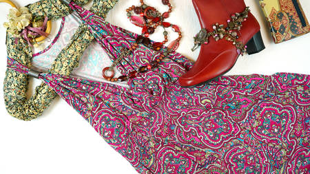 On-trend Boho Chic style fashion layout flat lay with red pink floral summer dress and accessories.