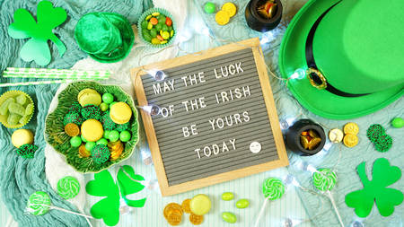 St Patricks Day flatlay with leprechaun hat, chocolate coins, and letter board.の写真素材