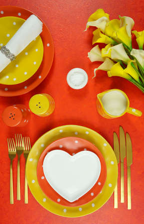 Orange and yellow aesthetic modern events table place setting top view flat lay.の写真素材