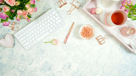 Blush pink cosy hygge style desktop workspace blog header overhead flat lay.