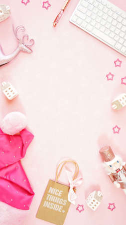Christmas shopping pink desktop workspace blog header overhead flat lay.の写真素材