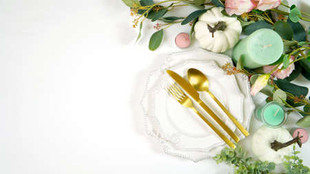 Happy Thanksgiving table setting with modern white pumpkins centerpiece.の写真素材