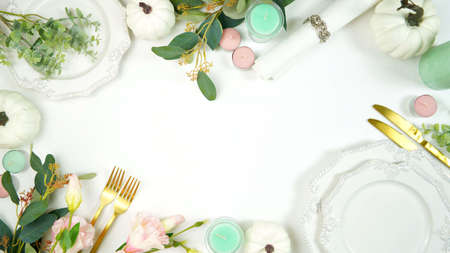 Happy Thanksgiving table setting with modern white pumpkins centerpiece.