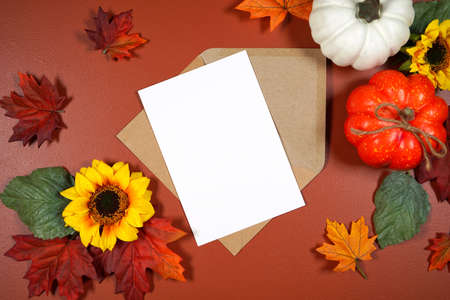 Autumn leaves and pumpkins theme product mockup flatlay on brown backgroundの写真素材
