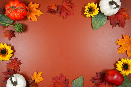 Autumn Fall theme flat lay background with pumpkins and maple leaves.の写真素材