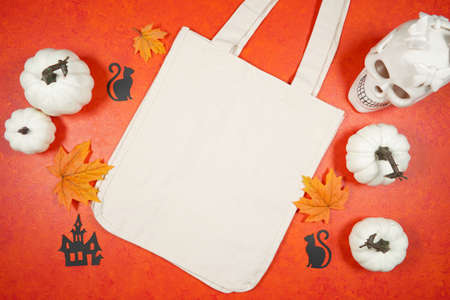 Halloween trick or treat product mockup with white skull and pumpkins.の写真素材