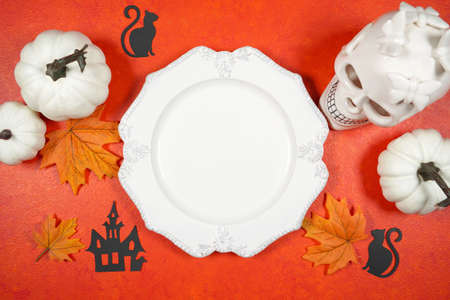 Halloween trick or treat product mockup with white skull and pumpkins.の写真素材