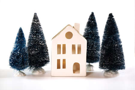 Christmas holiday background with white village house and tree ornaments.の写真素材