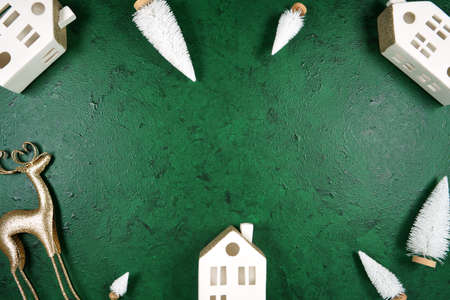 Christmas framed border background styled with village houses and gold reindeer.