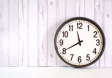 Happy New Year farmhouse clock on white wood background.の写真素材