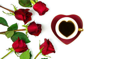Red roses creative flat lay layout with coffee in heart shaped cup and saucer.の写真素材