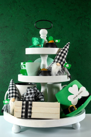 St Patricks Day farmhouse three tiered tray against green background.の写真素材