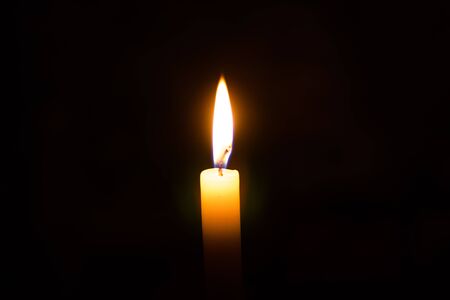 Candle flame against isolated on blackの写真素材