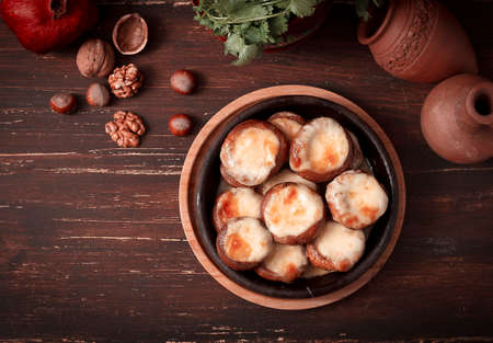 mushrooms baked with suluguni cheese on ketsi, a traditional Georgian dish, horizontal, no people