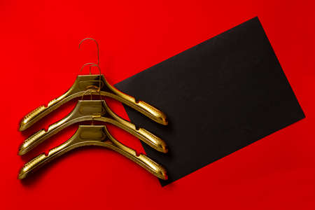Gold clothes hangers on red and black