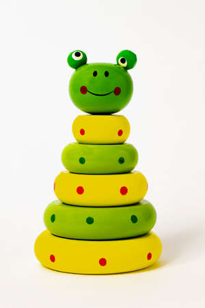 wooden toy, pyramid, frog on a white backgroundの写真素材