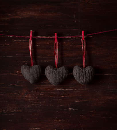 decoration heart, knittind, on a wooden backgroundの写真素材