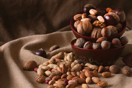 assortment of nuts, walnuts, hazelnuts, peanuts, almonds, chestnut pistachiosの写真素材