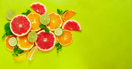 assortment of citrus fruits, on a yellow background, top view, no people, horizontalの写真素材