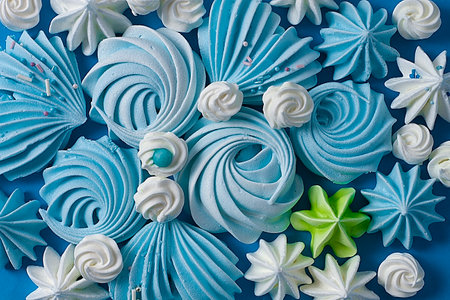 Assortment of meringues, on a blue background, vertical, no people,の写真素材