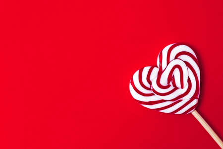 Lollipop in the shape of a heart, on a red background, Valetine, no people, horizontal,の写真素材
