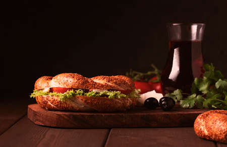 Traditional Turkish bagel simit, breakfast, on a wooden table, rustic, horizontal, no people,