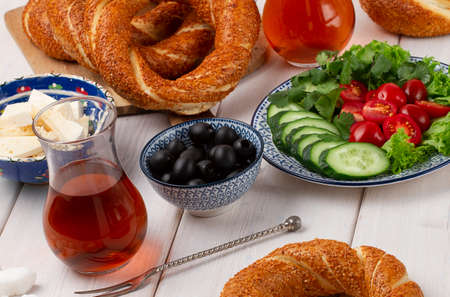 Traditional Turkish bagel simit, breakfast, on a wooden table, rustic, horizontal, no people,