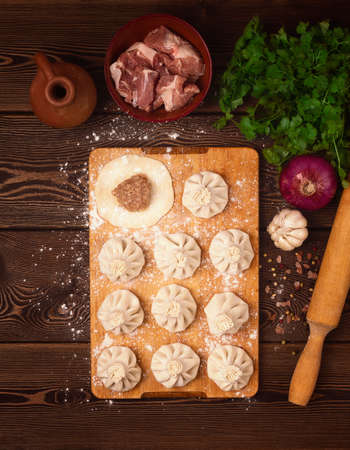 Traditional Georgian dish, Khinkali, raw, cooking, preparation, on a wooden table, top view, no people, selective focus, rustic style,の写真素材