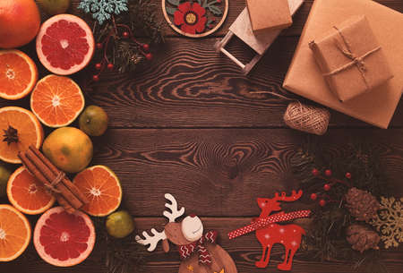 Concept, Christmas decorations, with gifts and a set of citrus fruits, on a wooden table, top view, selective focus, no people, rustic style,の写真素材