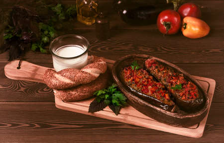 Turkish dish Imam Bayildy stuffed eggplant, karnyaryk, homemade, on a wooden table, rustic, no people, horizontal ,. High quality photoの写真素材