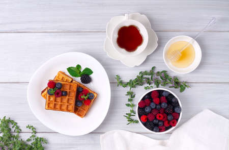 Viennese waffles, with berries, on a white table, breakfast, no people, horizontal,