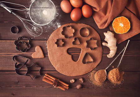Raw dough, Cookie cutter and gingerbread ingredients, on a wooden table, top view, flat layout, selective focus, vintage tinting, no people,の写真素材