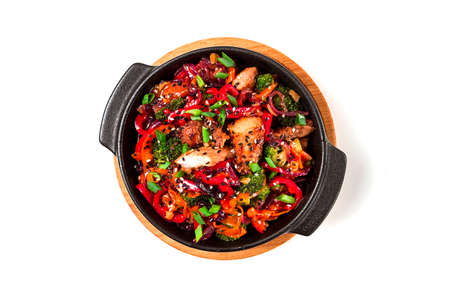 Asian cuisine teriyaki meat with vegetables, in a cast-iron frying pan, close-up, no people,の写真素材