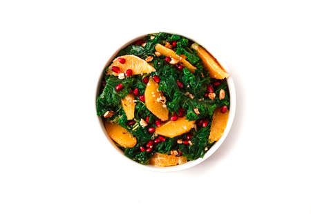 Kale cabbage salad with orange and pomegranate seeds, healthy food, top view, no people,