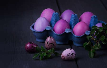 Easter eggs, purple and lilac on a gray wooden table, Easter card, banner, selective focus, horizontalの写真素材