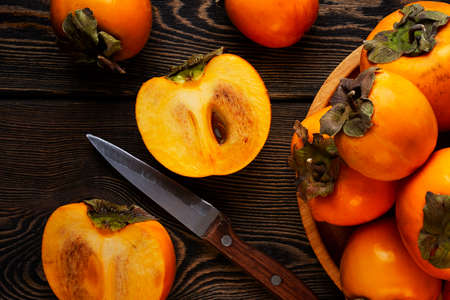 persimmon fruit, on a wooden table, top view, horizontal, no people,. high quality photoの写真素材